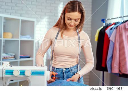Woman seamstress working at textile factory close up 69044634