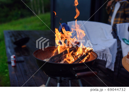 Bbq grill flame, hot burning grill outdoors cooking food. Grill burning fire for barbecue cooking outdoors. 69044732