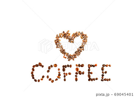 Heart shape made and inscription of roasted coffee beans isolated on white background. Close up of brown aroma caffeine drink black bean for coffee beverage Heart shape made and inscription of roasted coffee beans isolated on white background. Close up of brown aroma caffeine drink black bean for coffee beverage 69045401