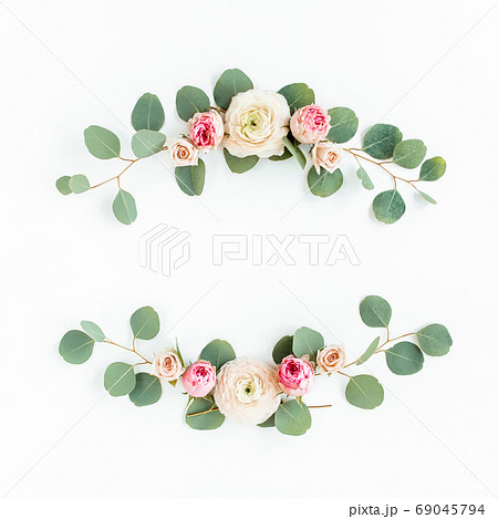 Wreath frame made of branches eucalyptus, pink ranunculus, roses and leaves isolated on white background. lay flat, top view Wreath frame made of branches eucalyptus, pink ranunculus, roses and leaves isolated on white background. lay flat, top view 69045794