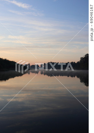 Beautiful calm sunrise dawn by river reflection Beautiful calm sunrise dawn by river reflection 69046167