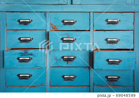 Old turquoise and brown colored wooden cabinet with drawers background Old turquoise and brown colored wooden cabinet with drawers background 69048599