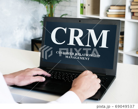 Customer relationship management CRM inscription on the laptop screen. 69049537