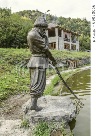 Sculpture of a fisherman with an abandoned net, on the river Agstev, near a pond near the city of Dilijan Sculpture of a fisherman with an abandoned net, on the river Agstev, near a pond near the city of Dilijan 69050056