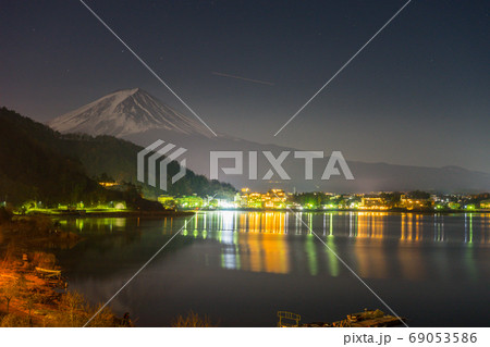 landscape view of Fuji Mountain and Kawaguchiko lake at night from Yamanashi Prefecture, Japan. landscape view of Fuji Mountain and Kawaguchiko lake at night from Yamanashi Prefecture, Japan. 69053586