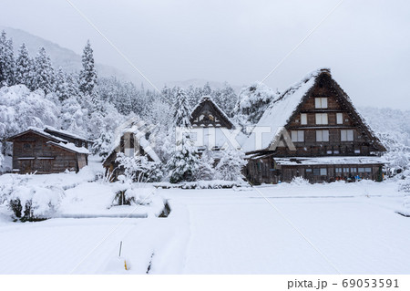 ancient houses and white snow is heavy and covered throughout  Shirakawa-go village in Gifu, Japan. 69053591