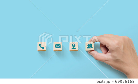 Hand putting wooden with symbol telephone, email, address 69056168