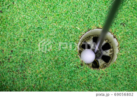 the golf ball in the golf hole. the golf ball in the golf hole. 69056802