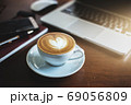 A latte coffee and laptop on the table.. 69056809