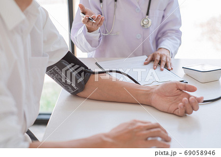 Doctor measuring and checking blood pressure of Doctor measuring and checking blood pressure of 69058946