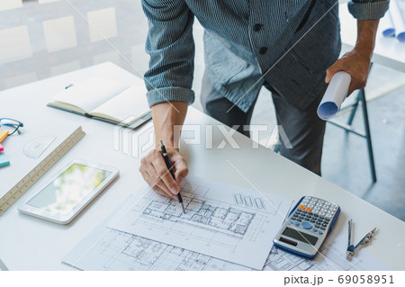Confident engineer team working with Blue Print Confident engineer team working with Blue Print 69058951