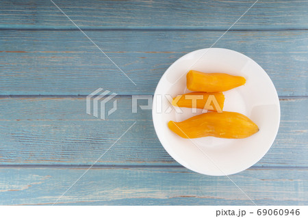 Ubi rebus or steam cassava is traditional malay dish on wooden background 69060946