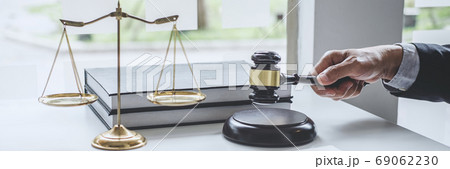Male lawyer or judge working with contract papers, Law books and 69062230