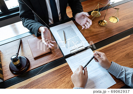 Male lawyer discussing negotiation legal case with Male lawyer discussing negotiation legal case with 69062937