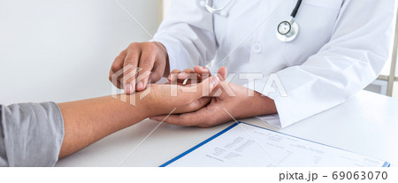 Doctor checking measuring pressure on patient's 69063070