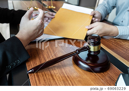 Male lawyer discussing negotiation legal case with 69063229