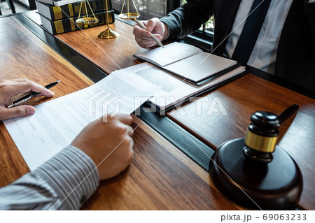 Male lawyer discussing negotiation legal case with Male lawyer discussing negotiation legal case with 69063233