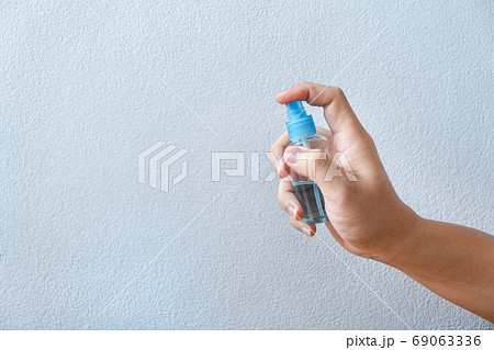 Image of hands using alcohol in bottle spraying Image of hands using alcohol in bottle spraying 69063336