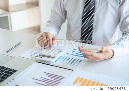 Young business man or accountant working on laptop 69063478