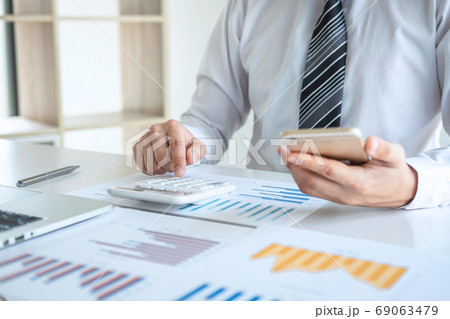Young business man or accountant working on laptop 69063479