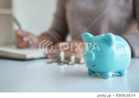 Young woman and piggy bank to planning growing Young woman and piggy bank to planning growing 69063654