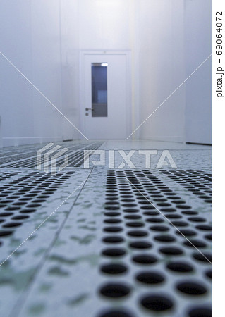 Inside white sterile cleanroom .Hallway with raised floor and door in cleanroom for pharmaceutical or electronic semiconductor industry. 69064072