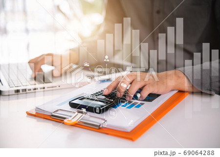 Businessman working with calculator, business document and laptop computer notebook at home office. 69064288