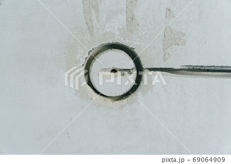 Holes in the concrete wall in the room for sockets 69064909