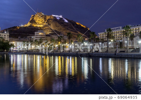 Night view of View of Alicante port Castle Santa Barbara on Mongo mount in background. Javea Xabia village.  69064935