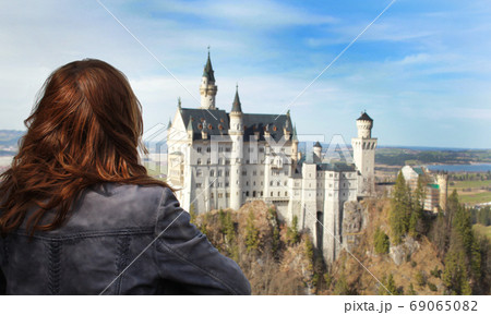 A girl looking at castle Neuschwanstein A girl looking at castle Neuschwanstein 69065082