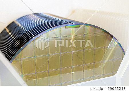 Silicon Wafers in white plastic holder box on a table Silicon Wafers in white plastic holder box on a table 69065213