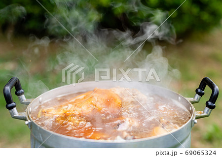 Stewed pork leg in silver pot on stove. Thai style food and outd 69065324