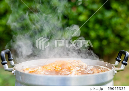 Stewed pork leg in silver pot on stove. Thai style food and outd 69065325