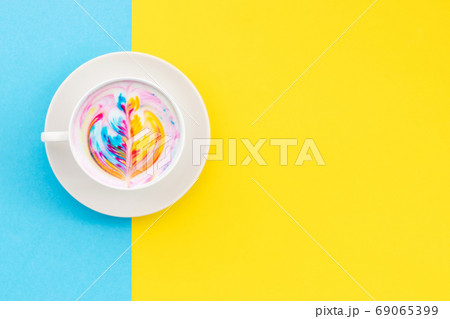 Top view white cup of hot Latte art coffee on yellow 69065399