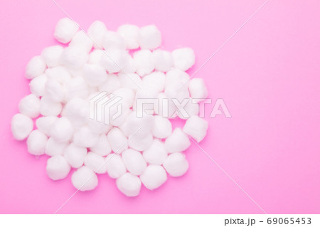Top view pile of white cotton wool on pink 69065453