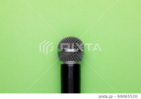 Black wireless microphone on color background. Copy space for te 69065520