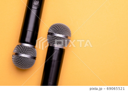 Black wireless microphone on color background. Copy space for te 69065521