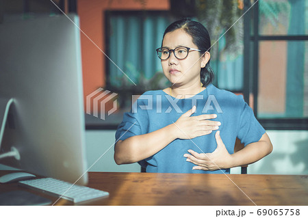 Asian woman looking computer screen to learning about checking b Asian woman looking computer screen to learning about checking b 69065758