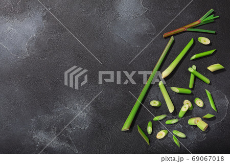 Lemongrass, cut stems atop dark textured backdrop w/ copy space, Lemongrass, cut stems atop dark textured backdrop w/ copy space, 69067018