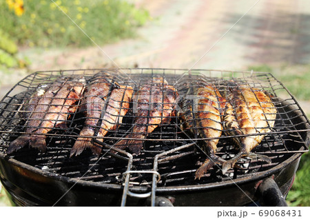 Fresh sea fishes on the grill outdoors. 69068431