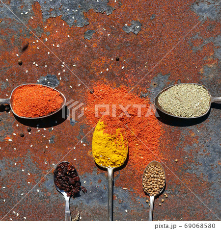 silver spoon with various spices 69068580