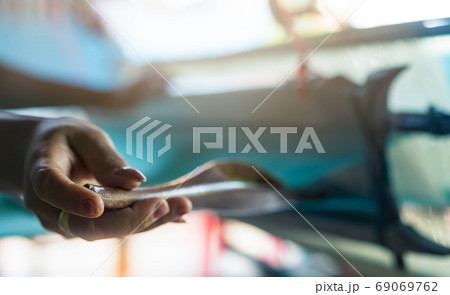 Woman working on weaving machine for weave handmade fabric. Text Woman working on weaving machine for weave handmade fabric. Text 69069762