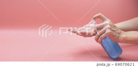 Woman hands using wash hand sanitizer gel pump dispenser. Clear Woman hands using wash hand sanitizer gel pump dispenser. Clear 69070621