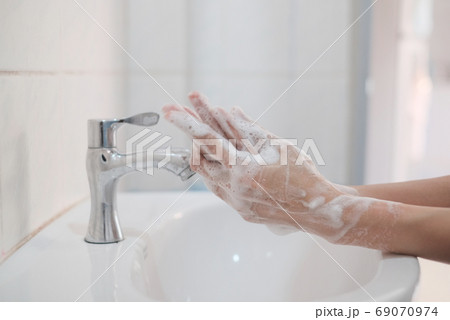 Woman washing hands, Corona virus travel prevention wash hands with soap and hot water. Hand hygiene for coronavirus outbreak. Protection by washing hands frequently concept. 69070974