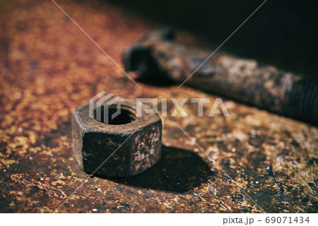 rusty nut and bolt on a rusty surface 69071434