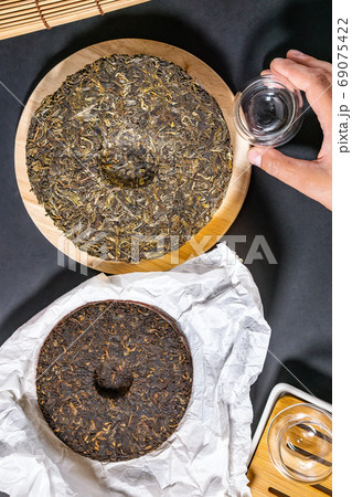 Chinese pressed PU-erh tea, pressed tea top view of a flat lay. Sheng Puer and Shu Puer Chinese pressed PU-erh tea, pressed tea top view of a flat lay. Sheng Puer and Shu Puer 69075422