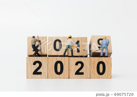 Miniature people : Worker team create wooden block number 2020  , Happy new year concept 69075720