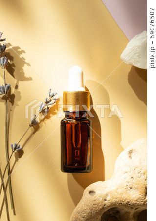 Brown bottle with cosmetic liquid. 69076507