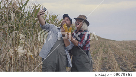 Farmers taking selfie with corn 69079365