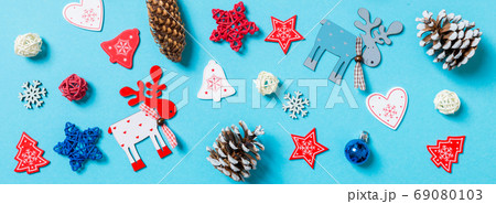 Top view of New Year toys and decorations on blue background. Banner Christmas time concept Top view of New Year toys and decorations on blue background. Banner Christmas time concept 69080103